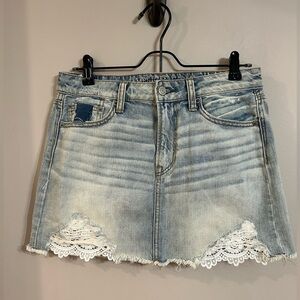 Women’s size 4 American Eagle distressed denim mini skirt with lace. Jean